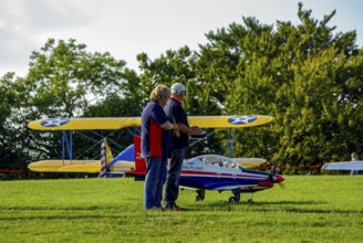 An RC model of a Pilatus PC-21 with advertising for the Swiss watch brand Breitling during a flight