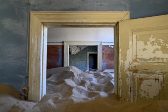 Sand mountains in a former dwelling house, interior photograph, Kolmanskop, restricted diamond
