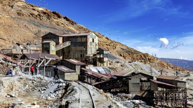 Historic industrial site on a mountainside under a clear blue sky, The silver mines of Potosi