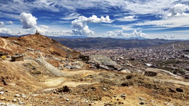 Dry mountain landscape with views of a town and an impressive sky full of clouds, view from Silver