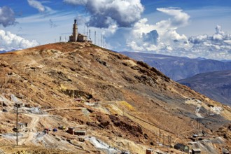 Single building with antennas on a bare hill under a dramatic sky, The silver mines of the Cerro