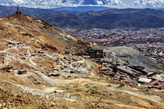 Far-reaching panorama of a city embedded in a mountainous landscape with clouds, The silver mines