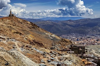 Sweeping views over a city in the middle of a mountain landscape under dramatic clouds, The silver