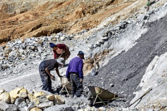 Labourers work together while moving gravel on a rough hillside, The silver mines of Potosi Bolivia