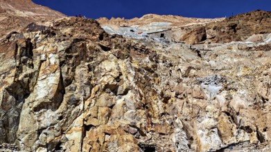 Textured rock face on a mountainside under a clear blue sky, The silver mines of Potosi Bolivia