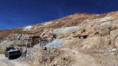 Stony landscape with an old lorry on an unpaved road, The silver mines of Potosi Bolivia