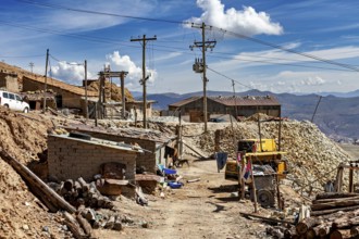 Mountain village with huts, racks and power lines under a clear sky, The silver mines of Potosi