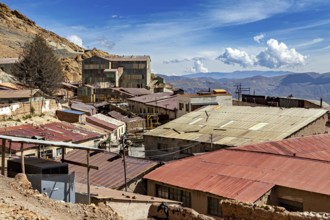 View of roofs and abandoned mine buildings with hills in the background, The silver mines of Potosi