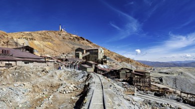 Abandoned mining infrastructure on a hill with a dramatic sky, The silver mines of Potosi Bolivia