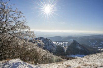 View over the hills and valleys from the mountain with hoarfrost on the branches in winter, Vápec,
