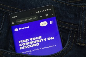 Dhaka, Bangladesh- 03 Oct 2025: A smartphone displaying the Discord web interface peeks out of a