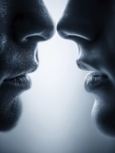 Symmetrical arrangement of two pairs of lips coming close together creates a feeling of intimacy,