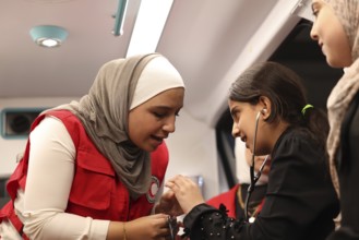Syrian Arab Red Crescent volunteers conduct first aid training for children during the Damascus