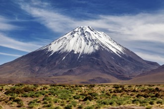 A single snow-covered peak rises majestically into the sky, The landscape with the volcanoes on the