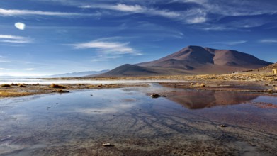 Majestic mountains reflected in calm waters under clear skies, The thermal springs of Polques in