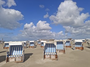 Sand drifts on the North Sea beach, blue sky, white clouds, summer, sun, sand, beach chairs, on the