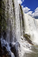 Detailed view of a cascading waterfall flowing over dark rocks, The Iguazu Falls between Argentina