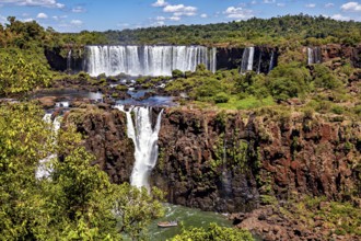 Wide waterfall with rocks and dense forest, peaceful and spectacular scenery, The Iguazu Falls