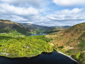 Farms and Mountains over road A591 from a drone, Grasmere Lake, Grasmere, Ambleside, Lake District,