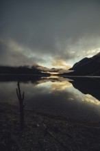 Sunrise with reflections in the Plansee in Tyrol in the Alps in Austria