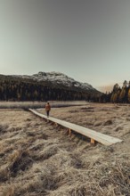 Young woman at Lake Staz near Sankt Moritz in the Engadine in Switzerland. Morning atmosphere with