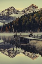 Lake Staz near Sankt Moritz in the Engadin in Switzerland. Morning atmosphere with fog in autumn.