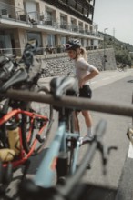 Young woman riding a racing bike on Lake Garda. Sunny weather and dolce vita