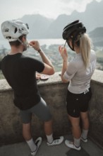 Young man taking a coffee break while riding his racing bike on Lake Garda. Sunny weather and dolce
