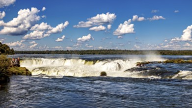 Wide waterfall under a cloudy sky in a beautiful landscape, The Iguazu Falls between Argentina and