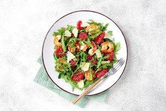 Fresh shrimp salad with arugula, grapefruit, and parmesan served in a bowl