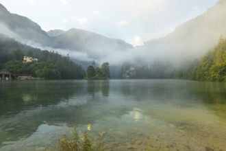 Mystical morning at Königssee in Schönau with boathouses and Christlieger. Sunrise and beautiful