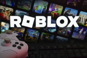 Dhaka, Bangladesh- 26 July 2025: A close-up of a white gamepad with The Roblox seen on screen in