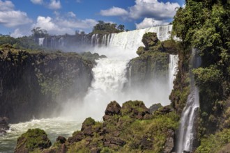 Mighty waterfalls cascade over rocky cliffs in nature, The Iguazu Falls between Argentina and