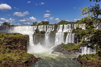 Impressive waterfalls with cliffs and spray under a blue sky, The Iguazu Falls between Argentina