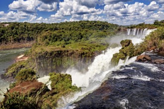 Impressive waterfall with foaming river and lush vegetation, The Iguazu Falls between Argentina and