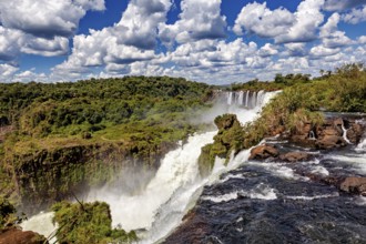 Large-scale waterfall landscape under a dramatic cloudy sky, The Iguazu Falls between Argentina and