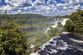 View over the waterfall and wooded surroundings under a cloudy sky, The Iguazu Falls between