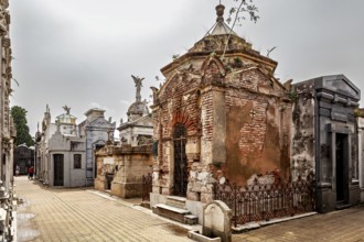 Old mausoleums in a cemetery with angel figures and weathered architecture, La Recoleta Cemetery in
