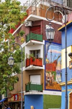 Colourful building with balconies and murals in a lively neighbourhood, the colourful city and