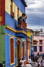 Lively street with balcony sculptures and colourful houses in La Boca, the colourful city and tango
