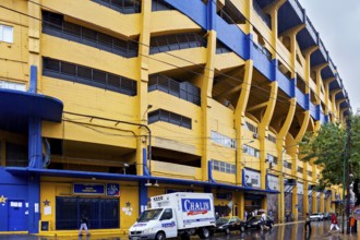 Yellow and blue stadium building on a rainy street, The football stadium of La Bocca of Bocca