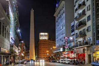 Night scene in a busy shopping street with the obelisk illuminated in the distance, The Great