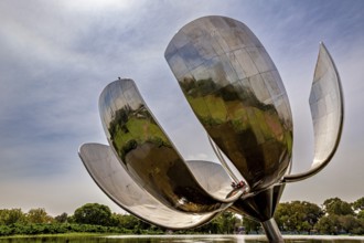 Close-up of a large metal flower sculpture with clouds in the sky, The lotus blossom in Buenos
