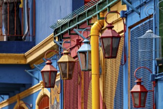Detailed view of colourful lanterns in front of vividly painted facades, The colourful city and
