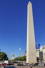 A tall obelisk under a clear sky in Buenos Aires in daylight, flanked by cars, The great obelisk in