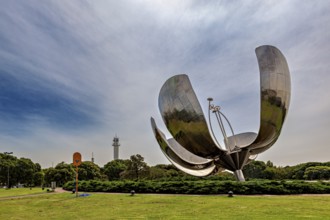 Metal flower sculpture in a park under a cloudy sky in daylight, The lotus blossom in Buenos Aires