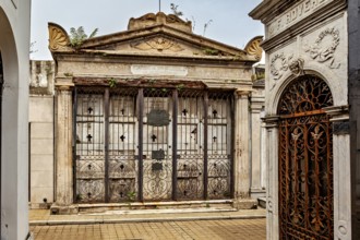 Ornate, dilapidated tomb with ironwork and lattice gate, La Recoleta cemetery in Buenos Aires