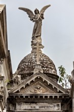 Angel sculpture on decorated dome above a historic building with Gothic design, La Recoleta