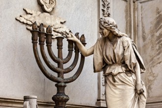 Stone statue of a woman touching a candlestick, artistic and detailed, La Recoleta cemetery in