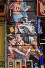 Artistic mural of dancing couples in vibrant colours on a city wall, The colourful city and tango